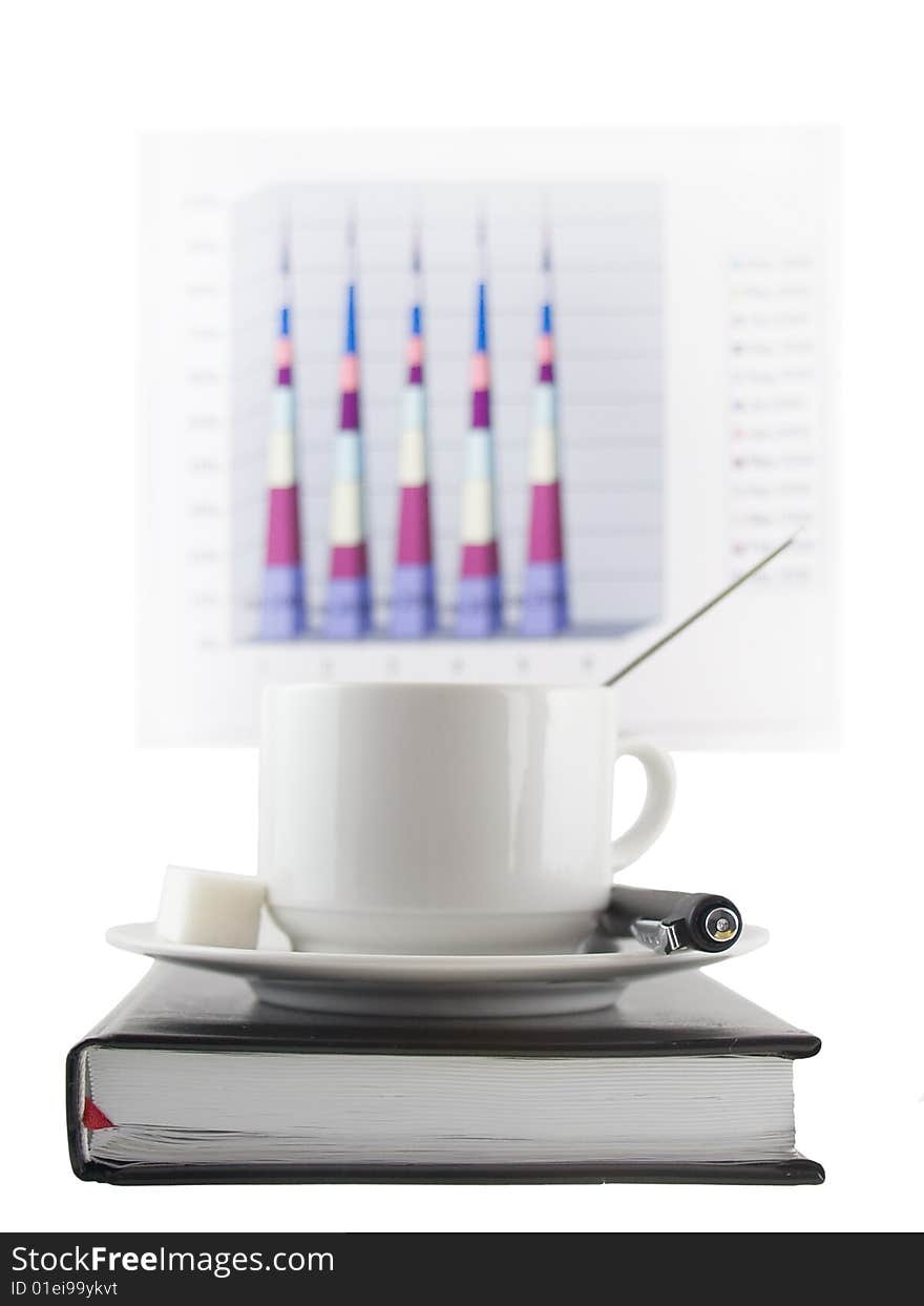 Coffee cup, standing on the black personal organizer, on a back background - financial  diagram . Focus at the pen and cup.Isolated on white. Coffee cup, standing on the black personal organizer, on a back background - financial  diagram . Focus at the pen and cup.Isolated on white.