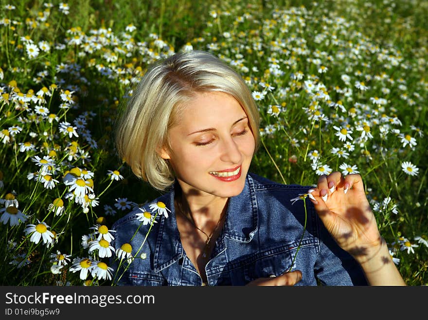 Young Woman With daisy in summer day