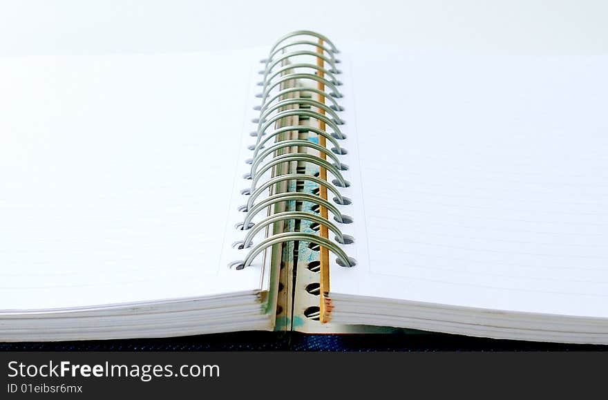 Open notebook with rings on white background