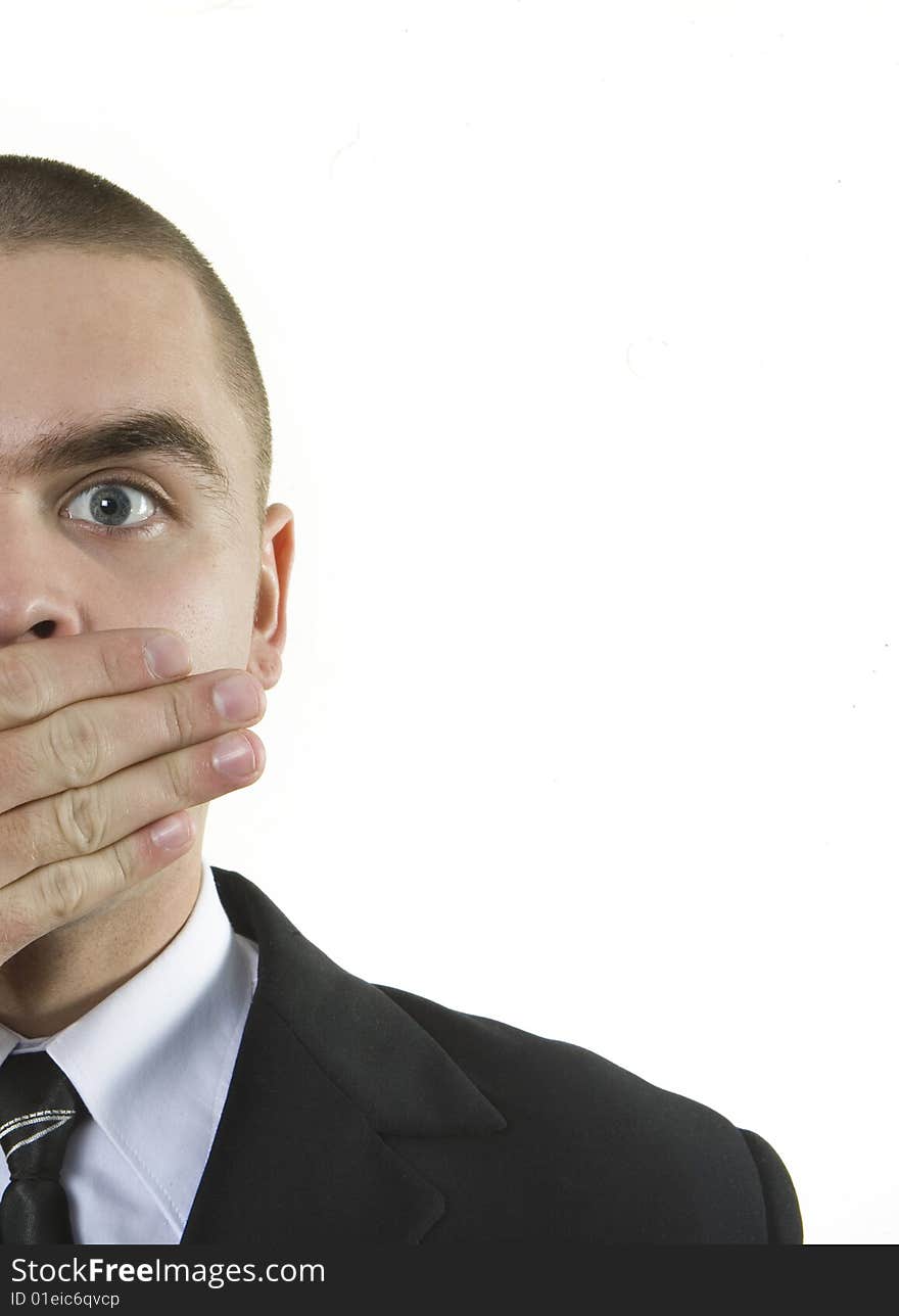 Half of young guy in a jacket, a shirt and a tie with a short hairstyle. The guy is surprised and closes a mouth a palm. A left-hand side of the guy