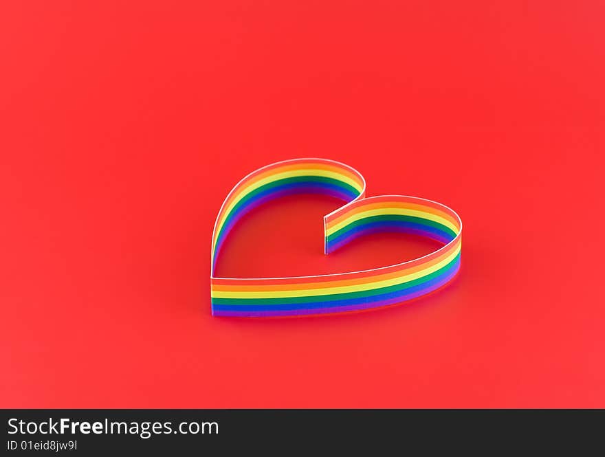 Single  heart, paint  of a six-colour gay flag on red background. Focus on front side. Single  heart, paint  of a six-colour gay flag on red background. Focus on front side.