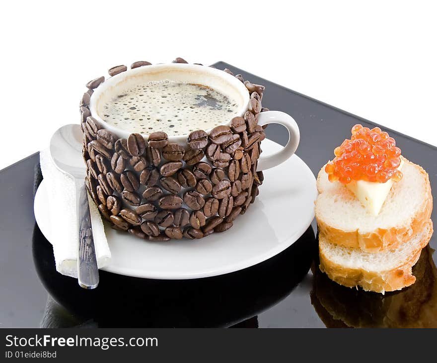 The coffee cup , original decorated by coffee grains(beans) with bread, butter , red caviar. Isolated on white. The coffee cup , original decorated by coffee grains(beans) with bread, butter , red caviar. Isolated on white.