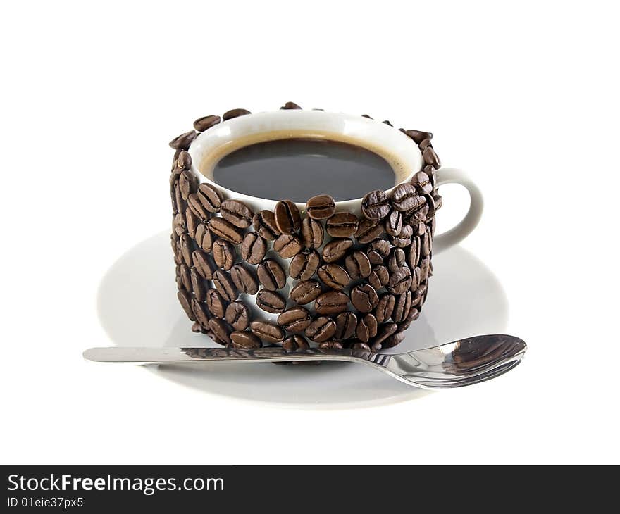 The cup of coffee  and  spoon, original decorated by  coffee beans. Isolated on white. The cup of coffee  and  spoon, original decorated by  coffee beans. Isolated on white.