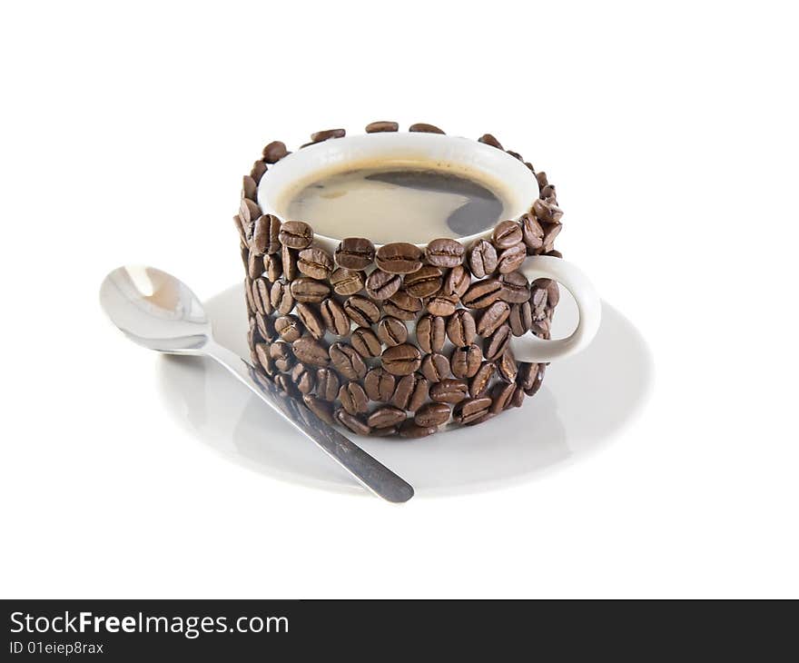 The cup of coffee  and  spoon, original decorated by  coffee beans. Isolated on white. The cup of coffee  and  spoon, original decorated by  coffee beans. Isolated on white.