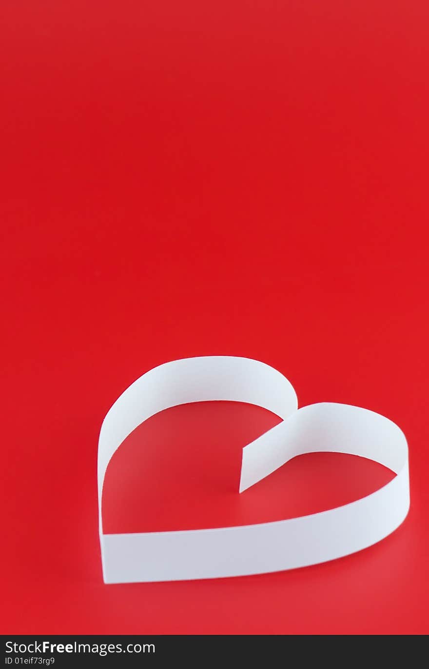 Single heart, on red background. Focus on the top part of heart. Single heart, on red background. Focus on the top part of heart.