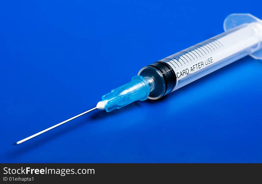 Syringe isolated on blue background. Syringe isolated on blue background