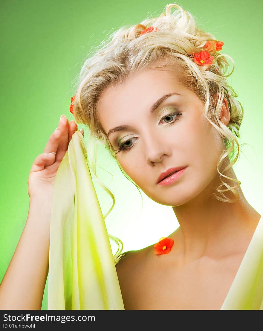 Portrait of a sad beautiful woman with flowers in her hair. Spring concept