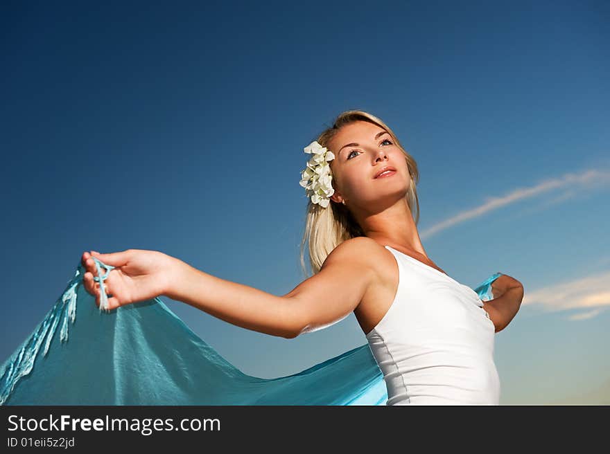 Beautiful young woman with a shawl relaxing outdoors