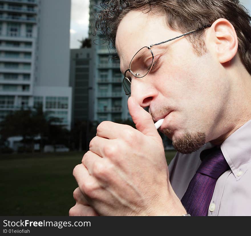 Young businessman smoking a cigarette. Young businessman smoking a cigarette