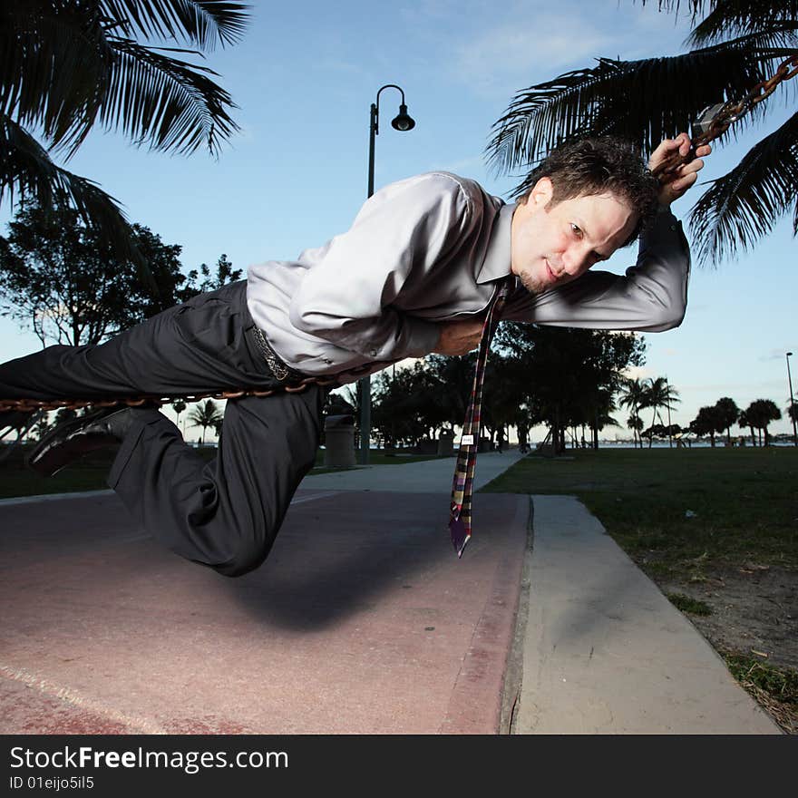 Businessman Handing On A Rope