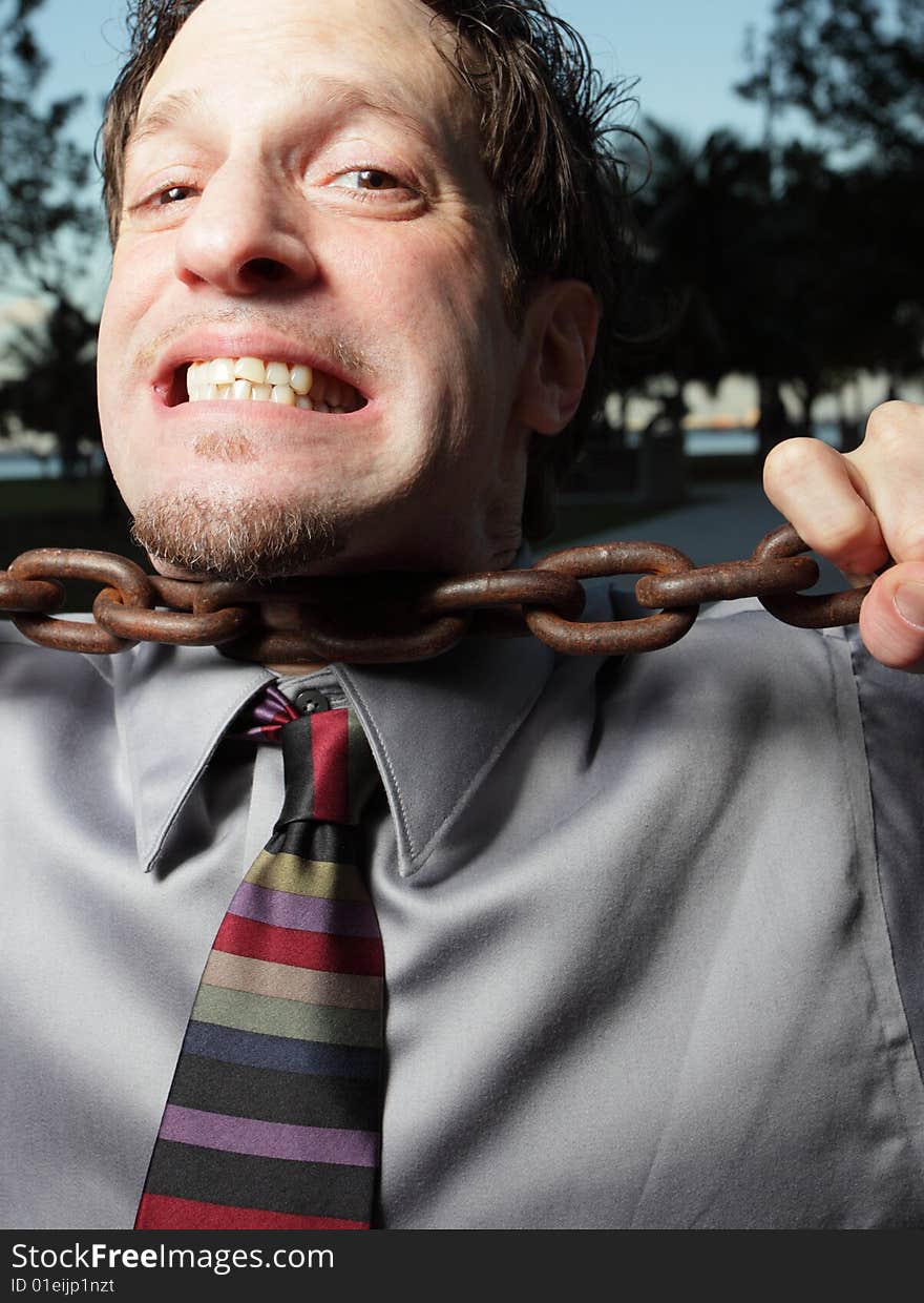 Businessman choking on a chain. Businessman choking on a chain