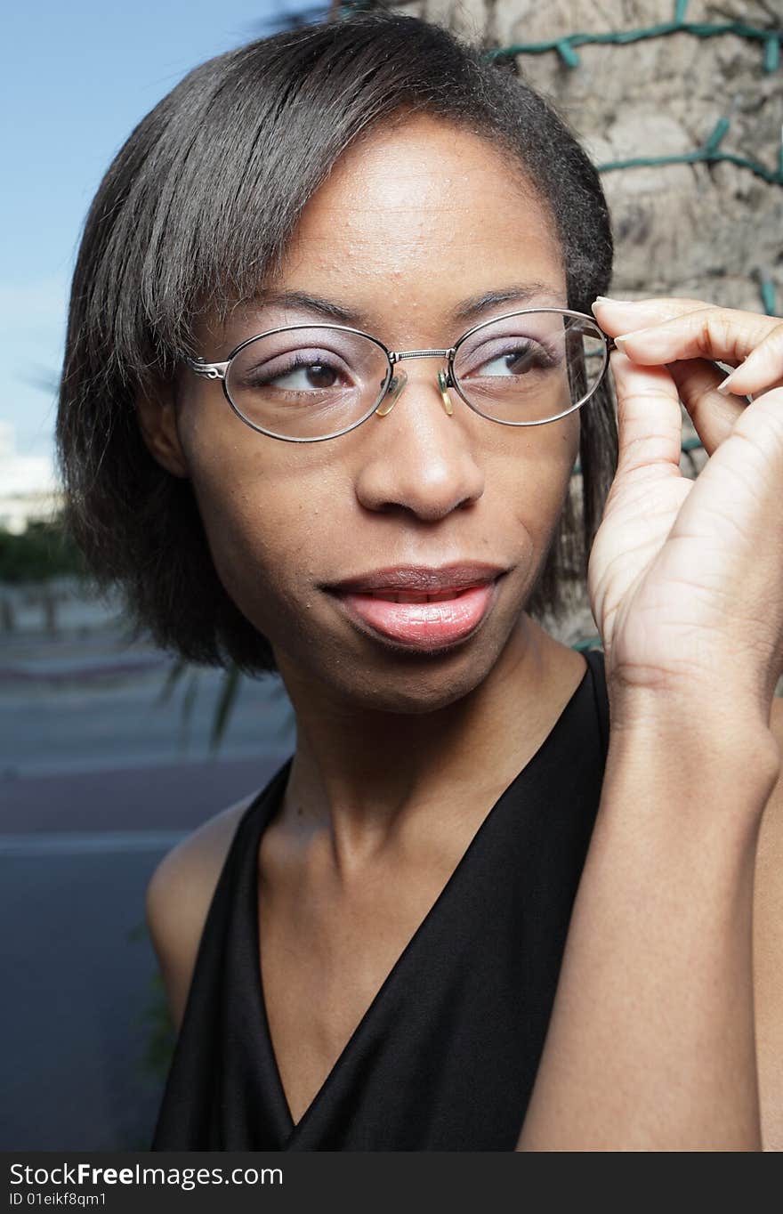 Woman adjusting her reading glasses