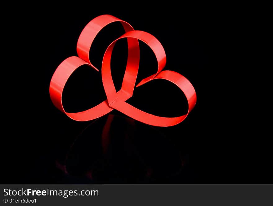 Two hearts with center spot light, on black  background. Two hearts with center spot light, on black  background.