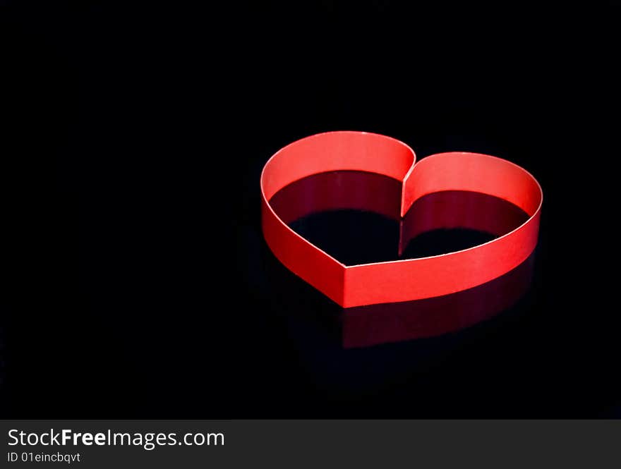 Two hearts with center spot light, on black  background. Two hearts with center spot light, on black  background.