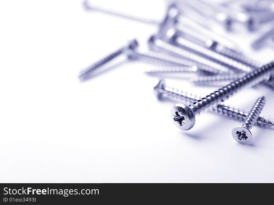 Metal screws closeup on white background