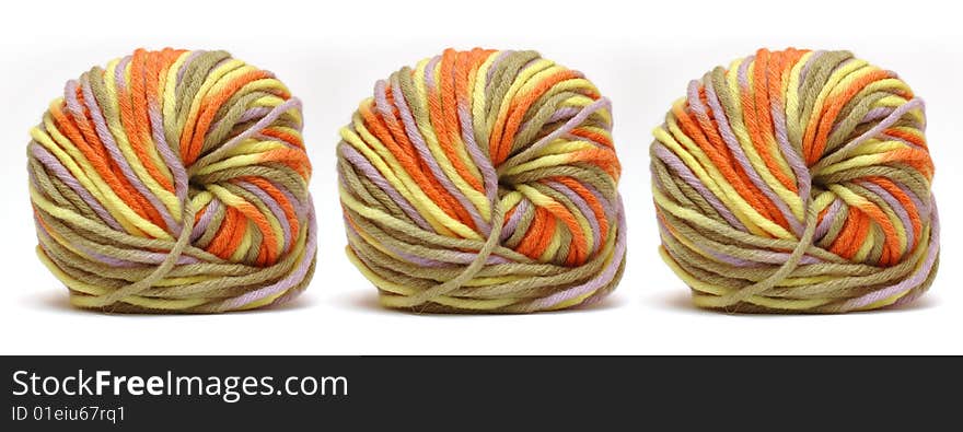 Tree bales of colorful yarn isolated over white