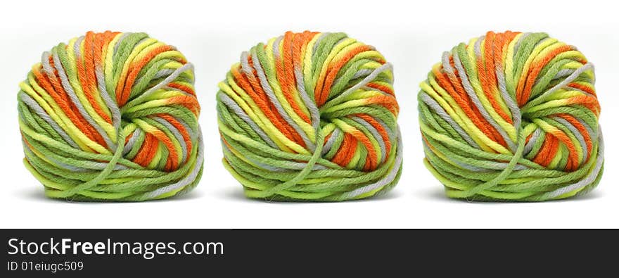 Tree bales of colorful yarn isolated over white