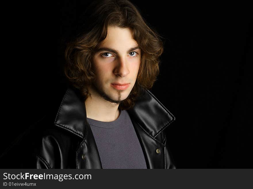 A portrait of an attractive young man against a white background.