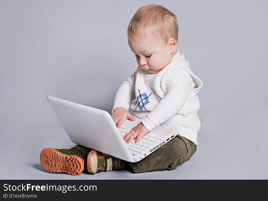 Small baby with white laptop