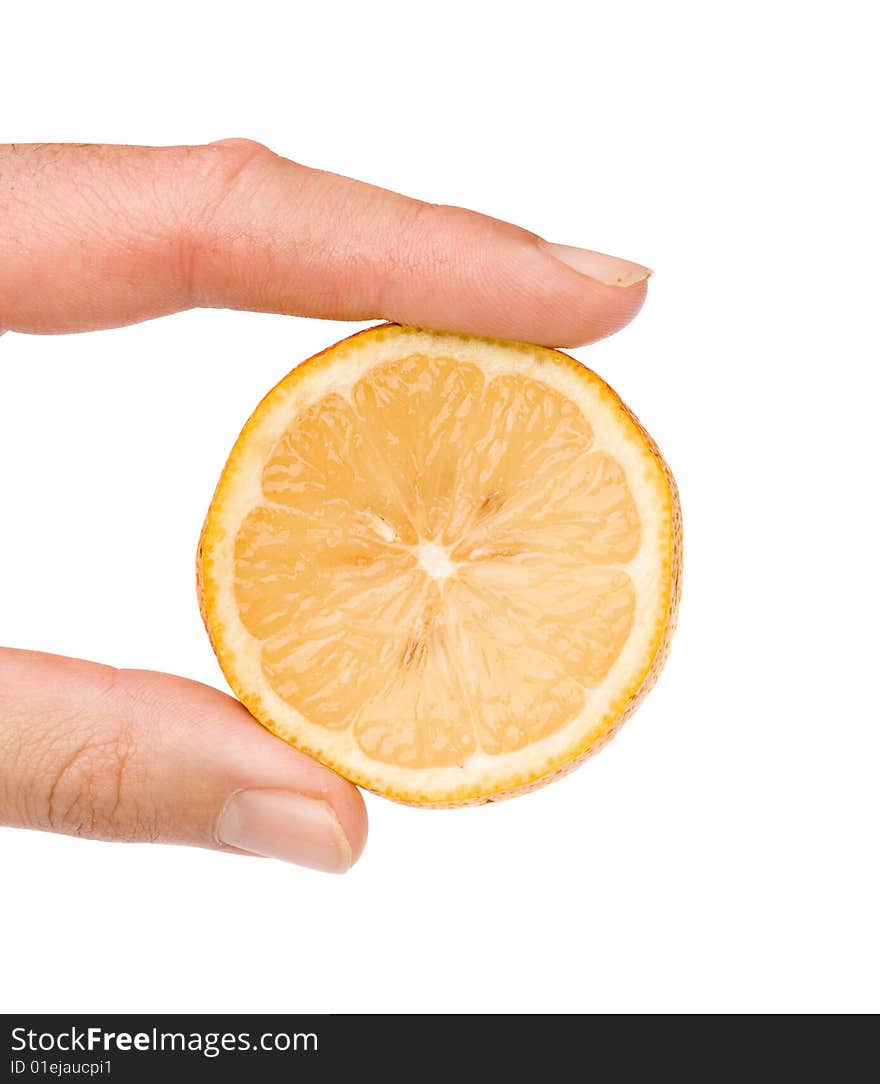 Close up of hand holding a slice of lemon