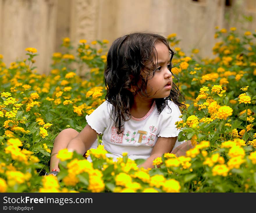 Beautiful girl among flowering plants