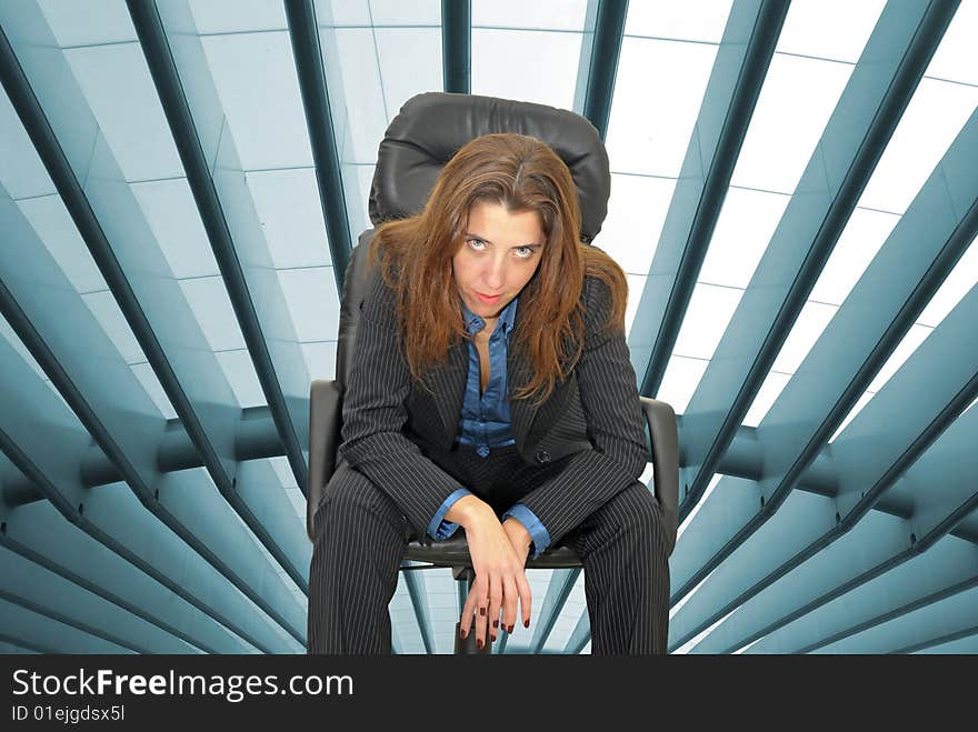 Businesswoman with a modern trainstation as background