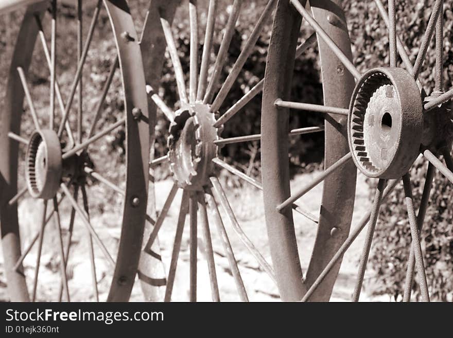 View of three metal wheels in sepia. View of three metal wheels in sepia