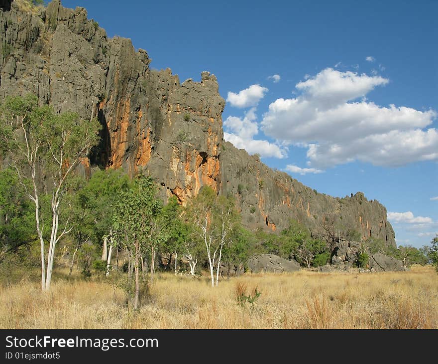 Australian landscape with geological feature of rock formations and specific vegetation. Windiana Gorge National Park, Western Australia, Australia.