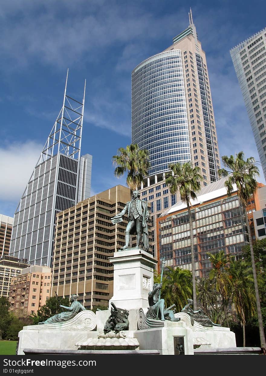 Monument against Sydney's skyscrapers surrounded with azure cloudscape. Sydney, NSW (New South Wales), Australia