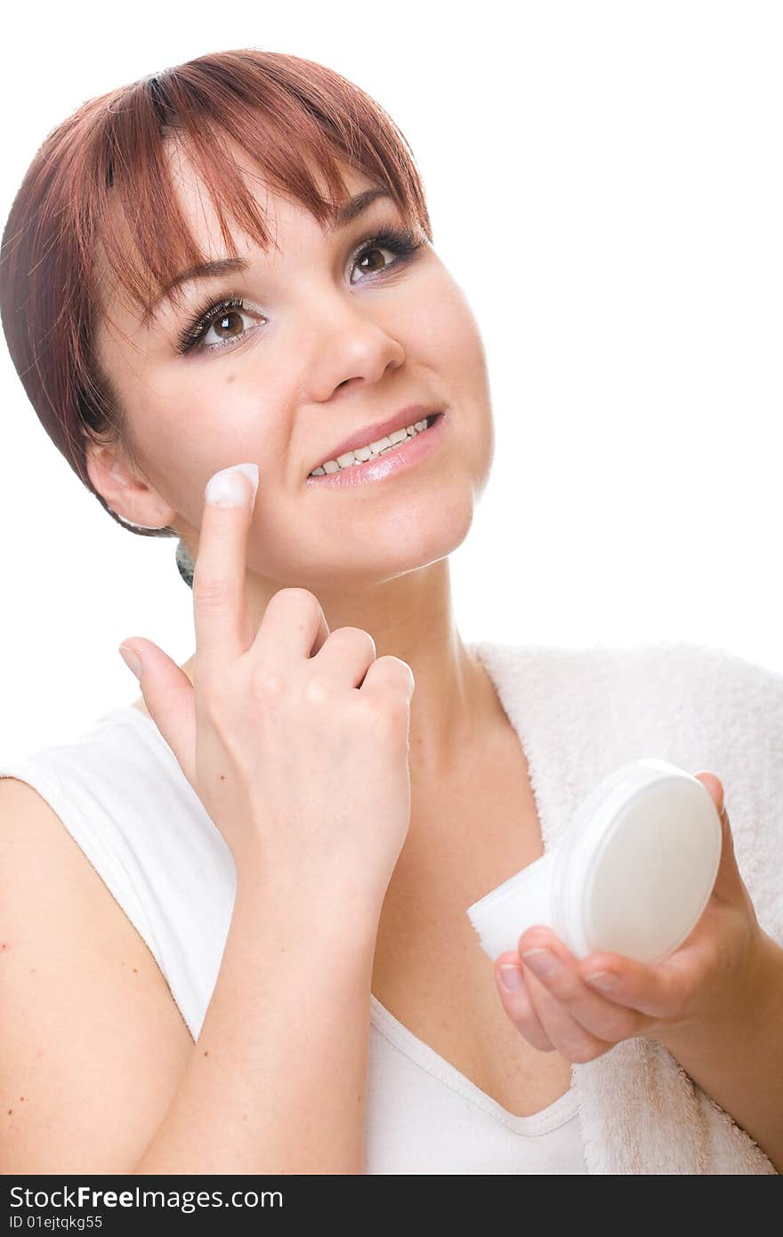 Attractive  woman applying cream. over white background. Attractive  woman applying cream. over white background