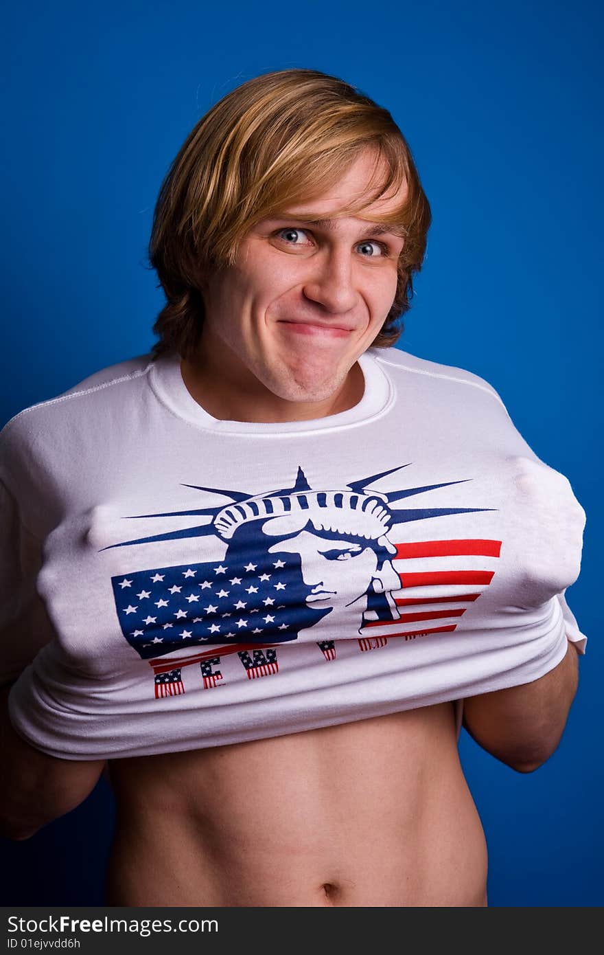 Funny smiling blond man in white T-shirt with symbol of America. Funny smiling blond man in white T-shirt with symbol of America