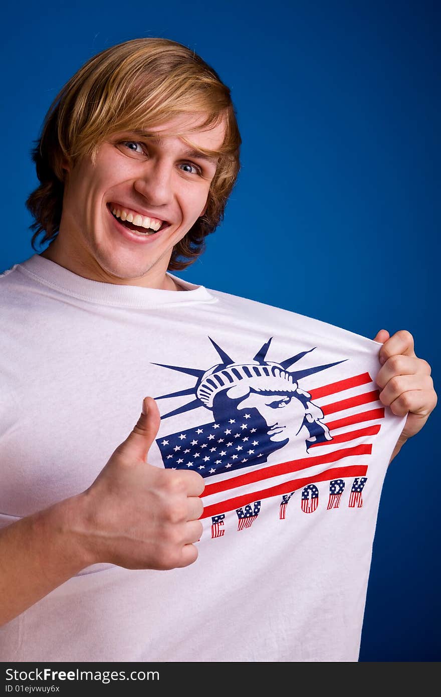 Hello, America! Funny smiling blond man in white T-shirt with symbol of America. Hello, America! Funny smiling blond man in white T-shirt with symbol of America