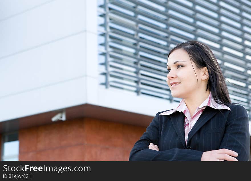 Attractive brunette businesswoman in front of office. Attractive brunette businesswoman in front of office