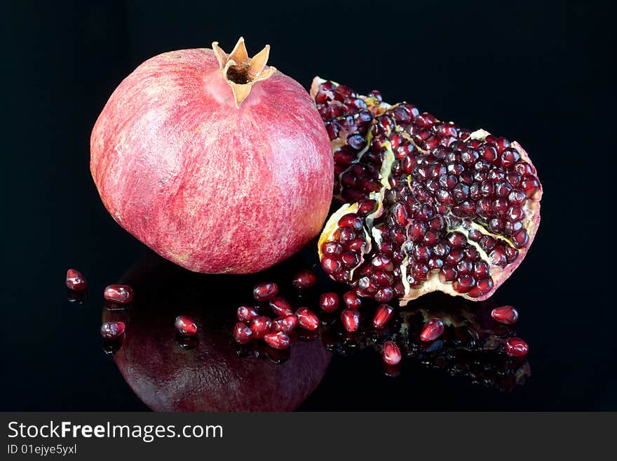 Pomegranate on a black background. Pomegranate on a black background.