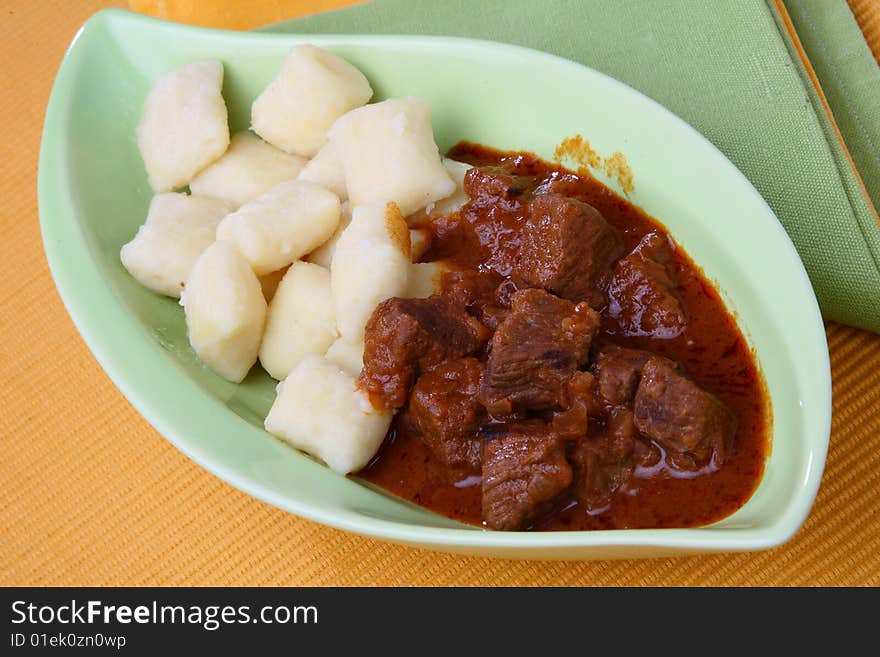 Beef goulash with gnocchi on plate