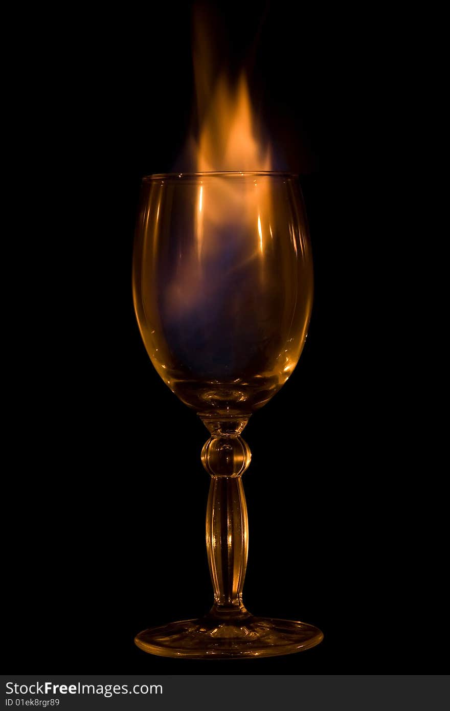 Glass, cocktail, fire. Isolated on a black background