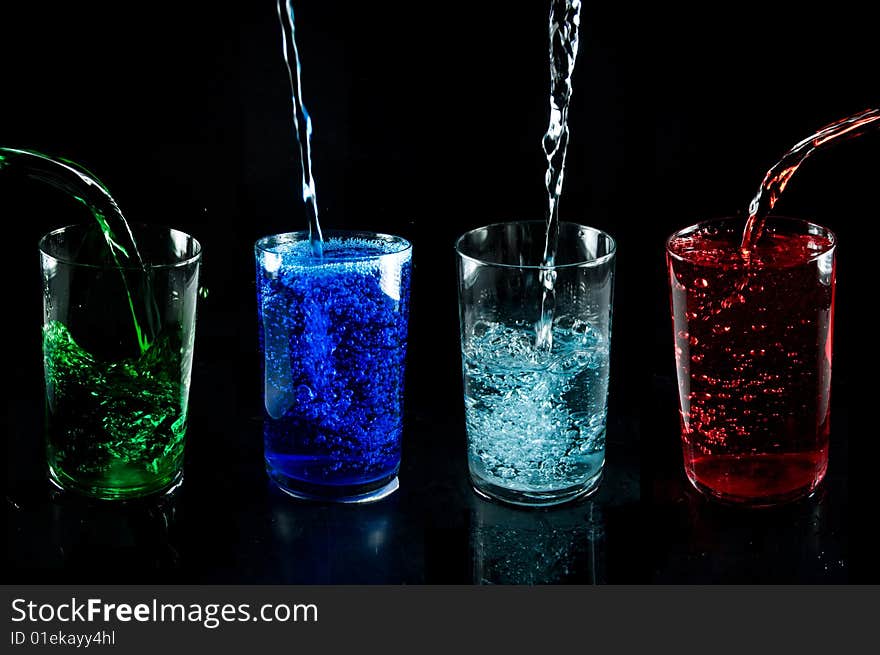 Glass with drink on a black background