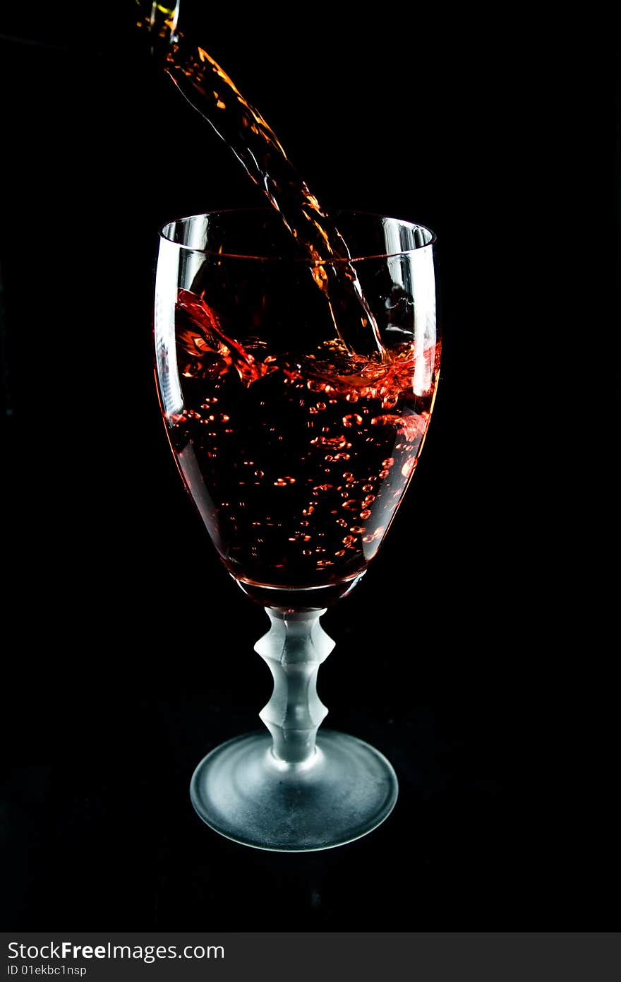 Glass of wine on a black background