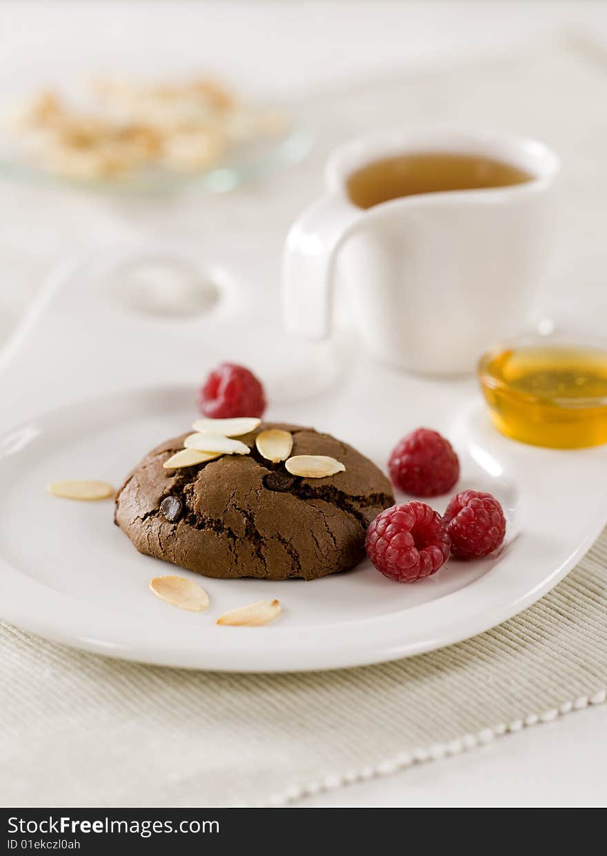 Chocolate cookie with raspberries  and tea. Chocolate cookie with raspberries  and tea