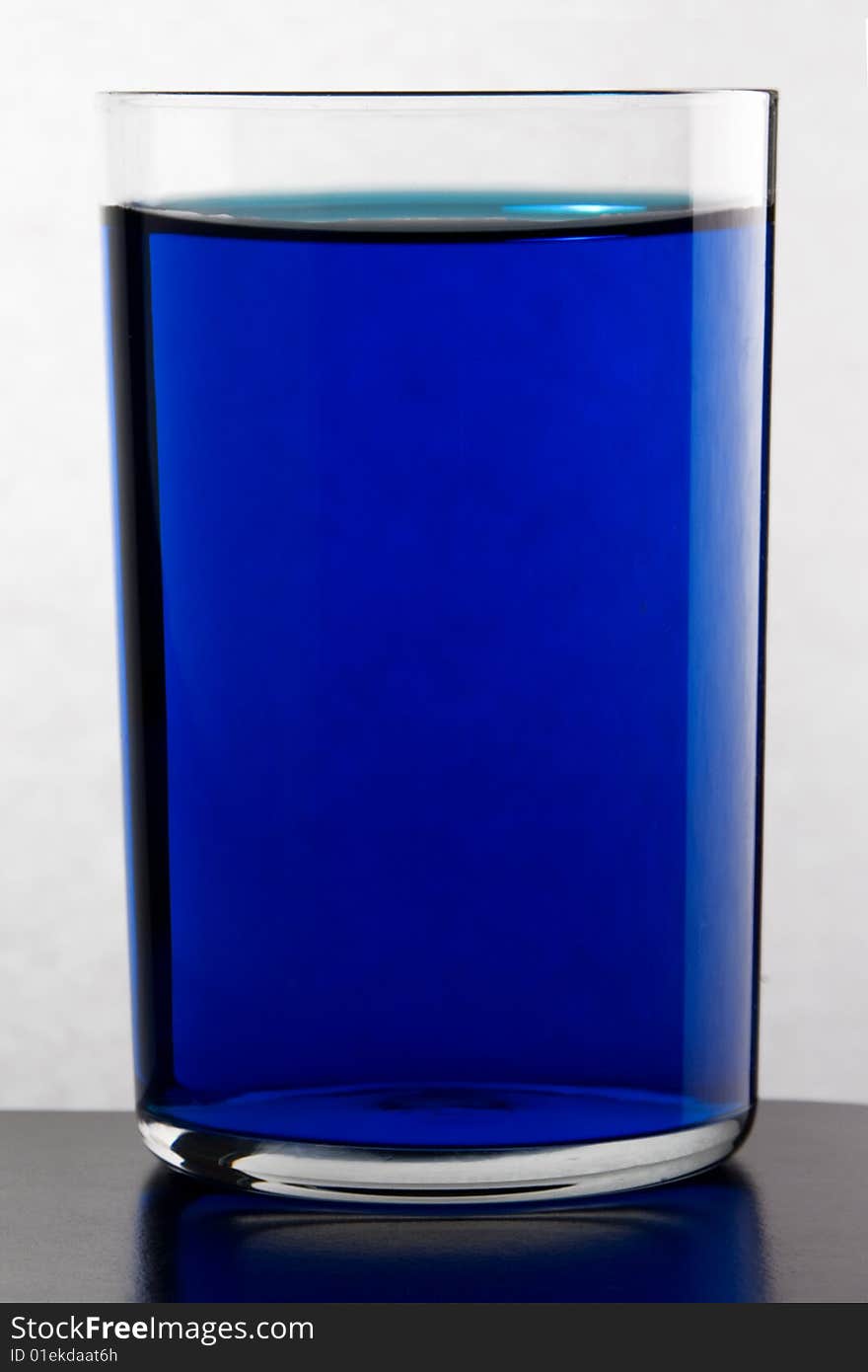 Glass with drink blue color. Glass with drink blue color