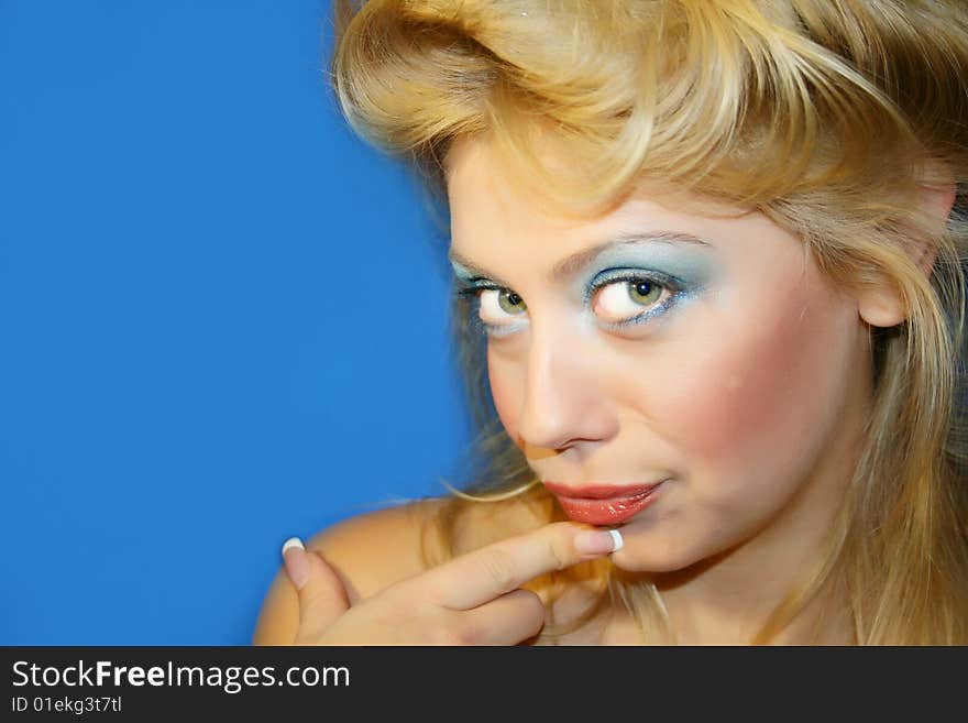 The young beautiful girl on a dark blue background. The young beautiful girl on a dark blue background