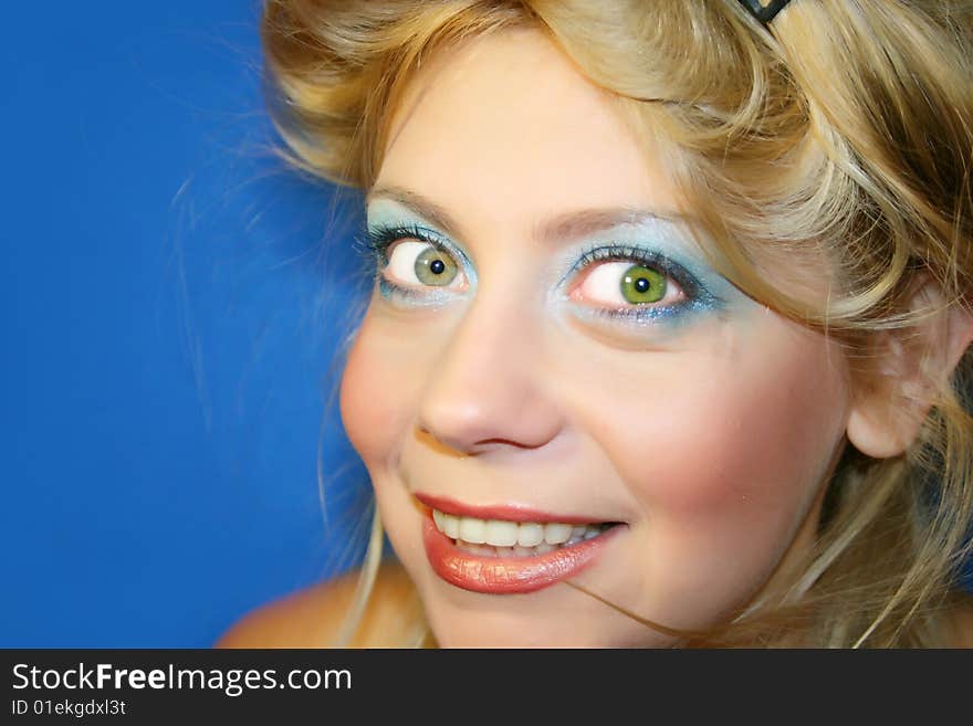 The young beautiful girl on a dark blue background. The young beautiful girl on a dark blue background