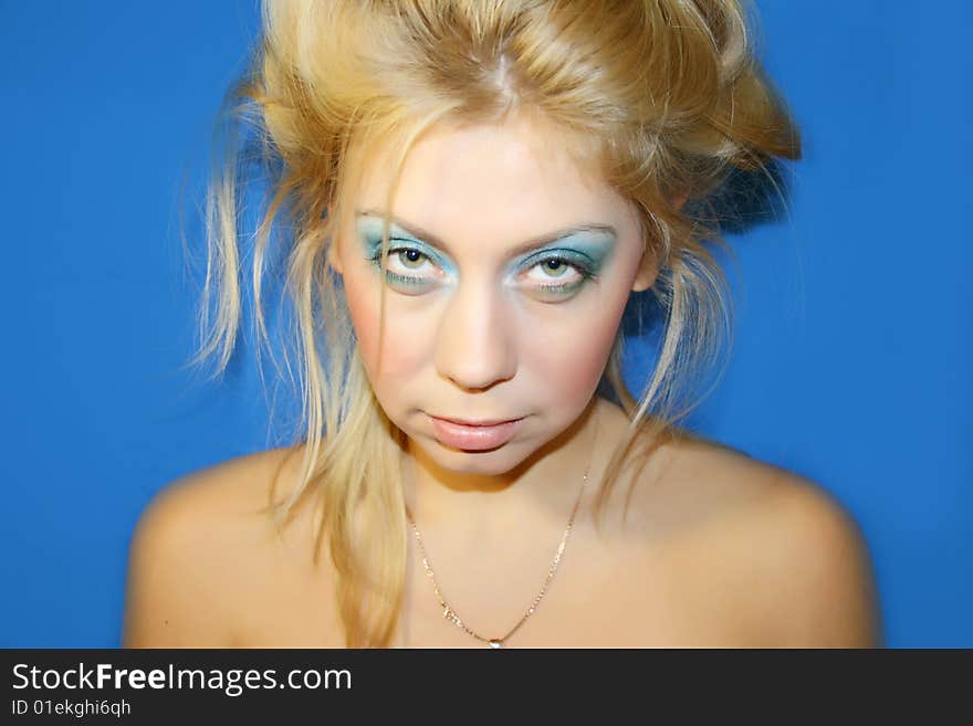 The young beautiful girl on a dark blue background. The young beautiful girl on a dark blue background