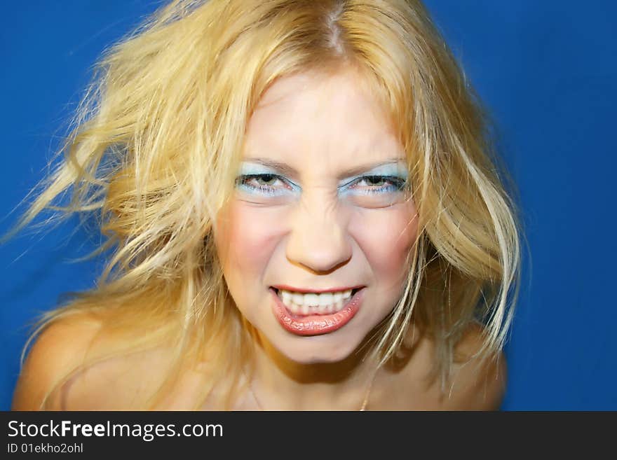 The young beautiful girl on a dark blue background. The young beautiful girl on a dark blue background