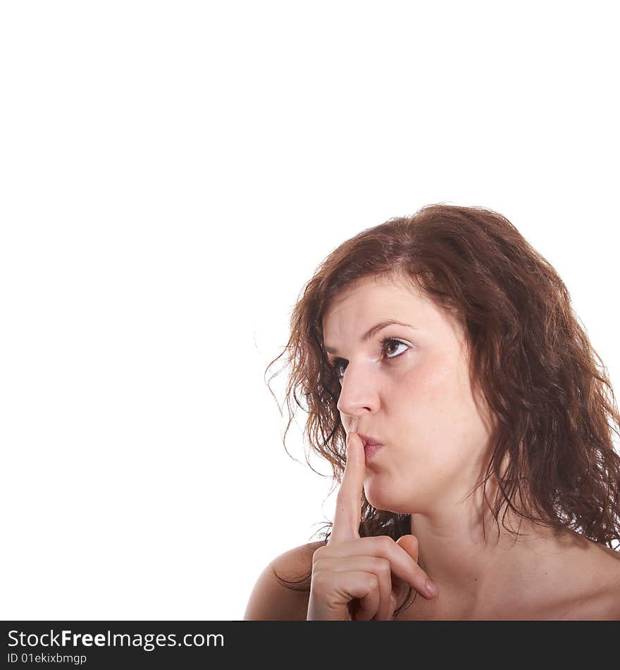 A young beautiful woman with a finger over her lips. Isolated over white with a lot of copy space. A young beautiful woman with a finger over her lips. Isolated over white with a lot of copy space.