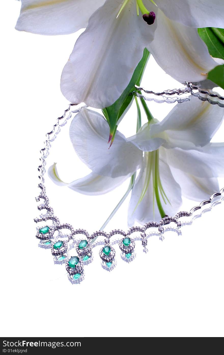 Emerald necklace from white gold and a lily. Emerald necklace from white gold and a lily