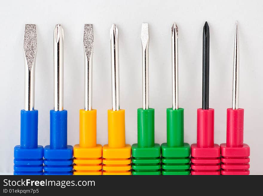 Colorful screwdrivers on white background