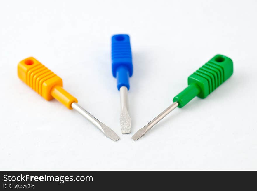 Colorful screwdrivers on white background