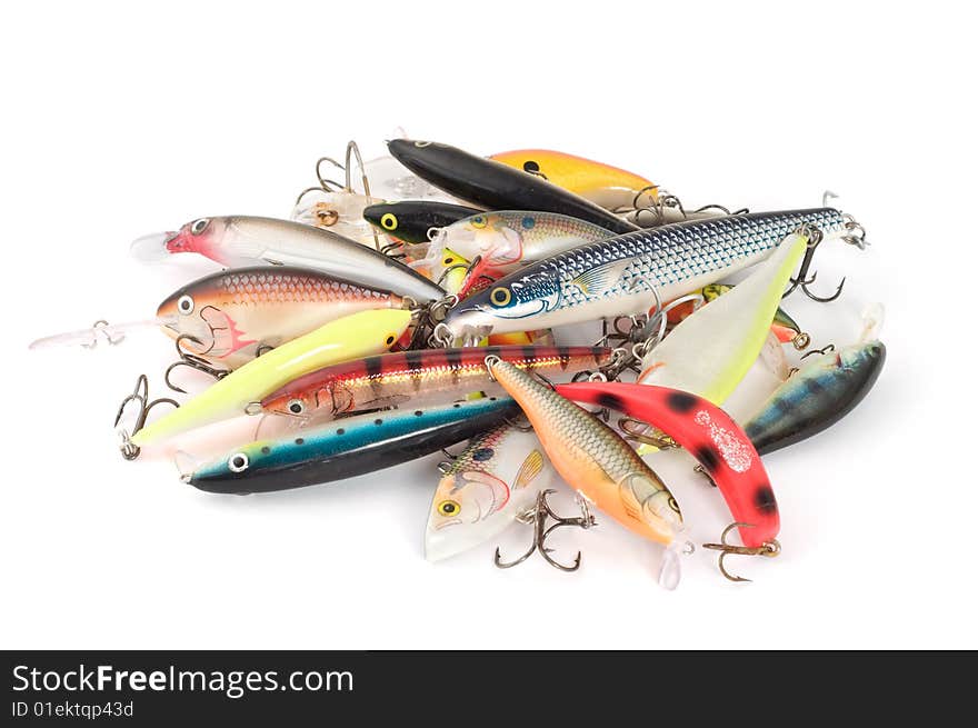 Disordered fishing lures on white background