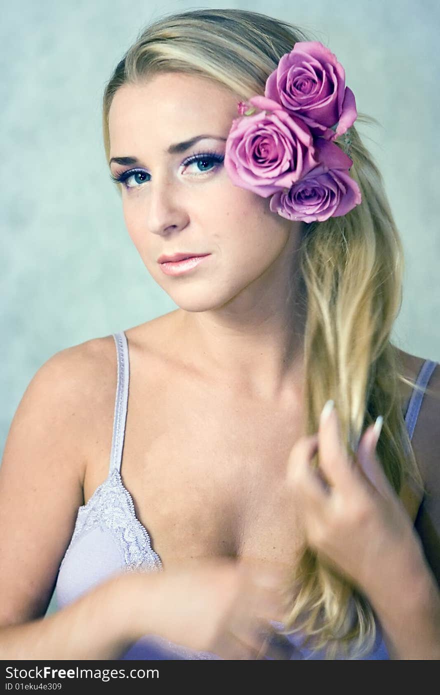 Beautiful girl with rose flowers in her hair. Beautiful girl with rose flowers in her hair